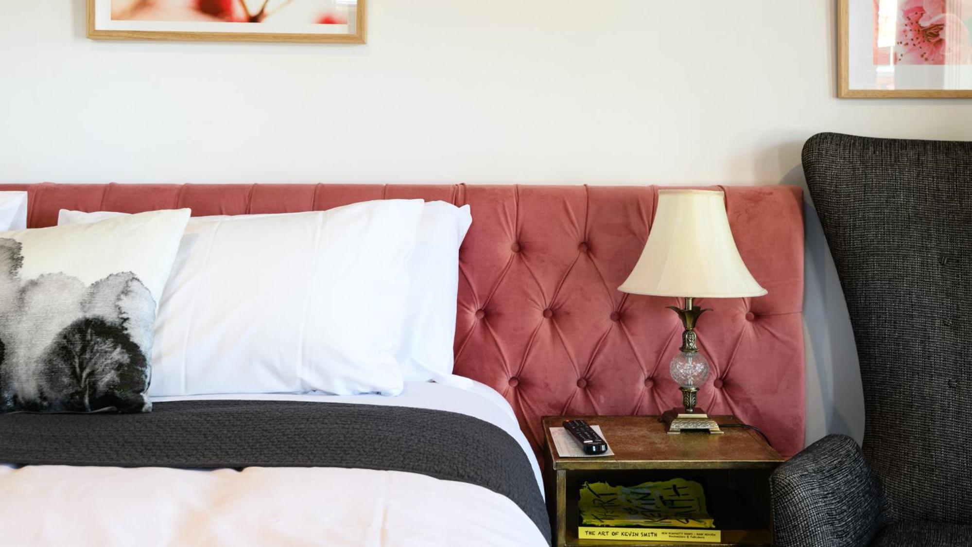 Daylesford Art Motel Exterior photo A bed with a tufted headboard